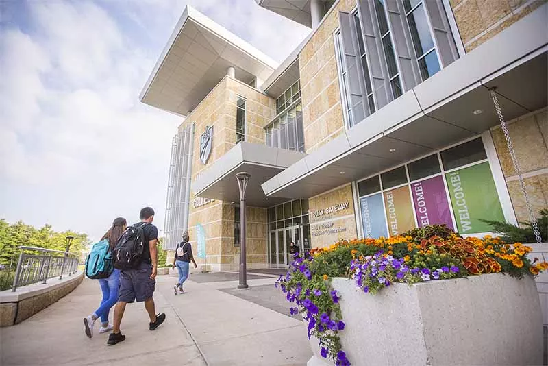 People walking into campus building