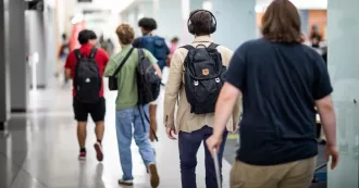 Madison College students walking in the Truax campus hallway.