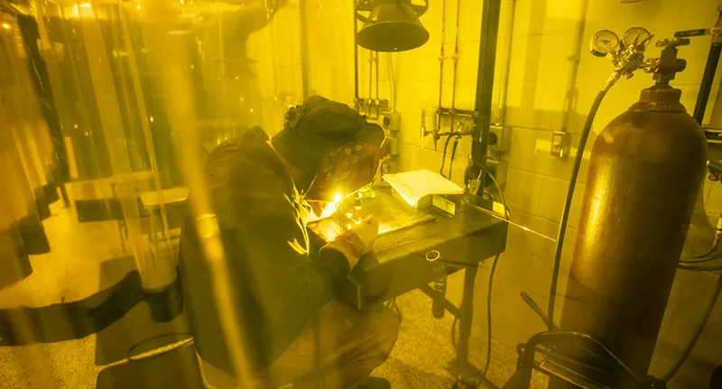 Student in welding booth at Fort Atkinson campus