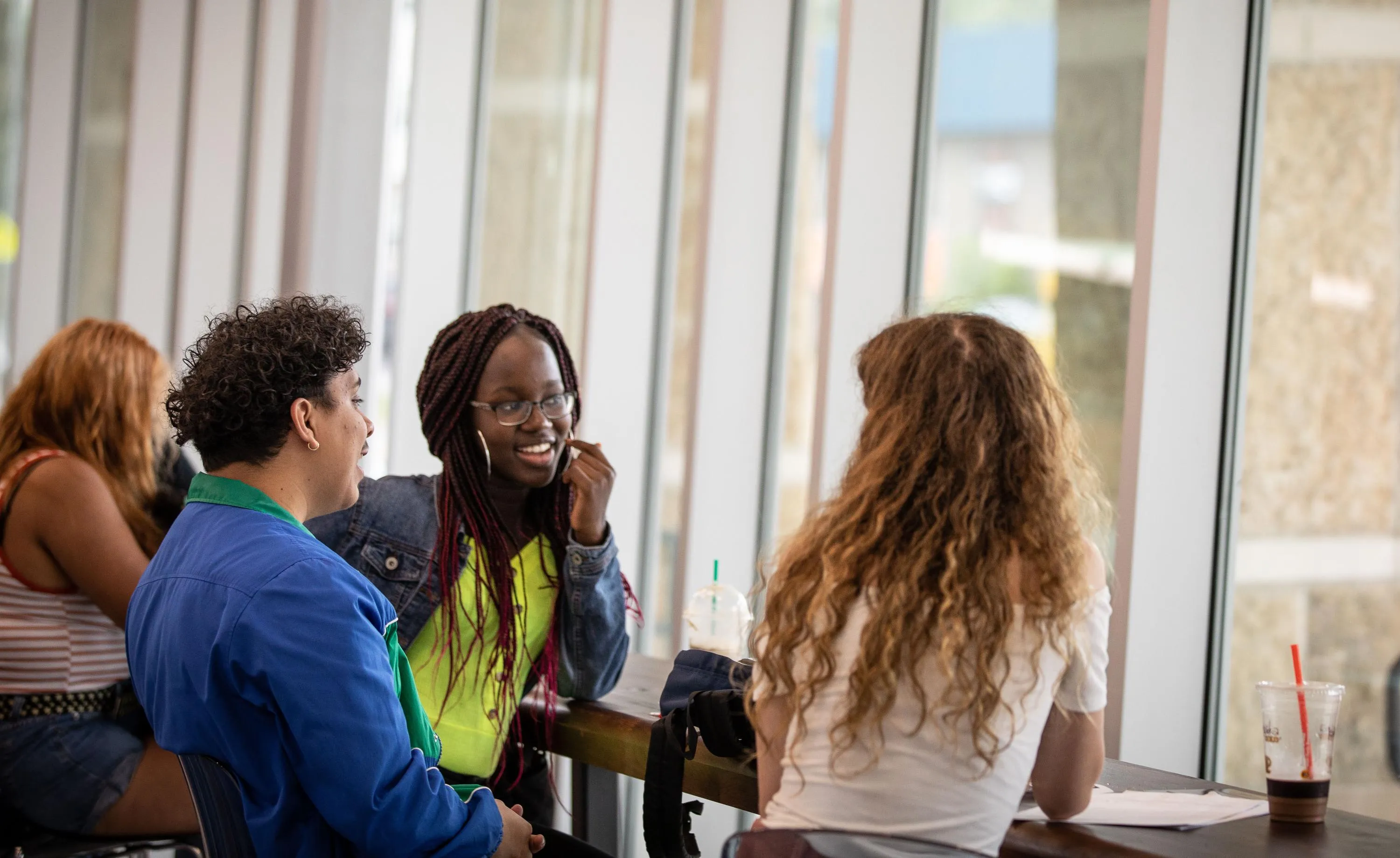 Students setting at a table at the Madison College Truax campus.