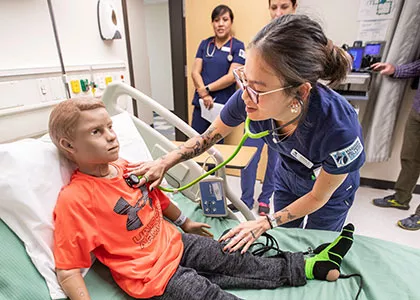 nursing students practicing on a medical mannequin