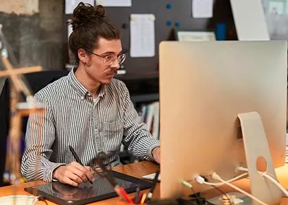 Madison College animation student using a stylus pen