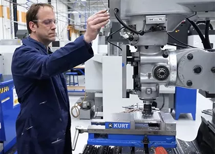 Madison College student using a drill press to make something