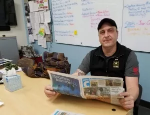Brad Burt holds Clarion newspaper.