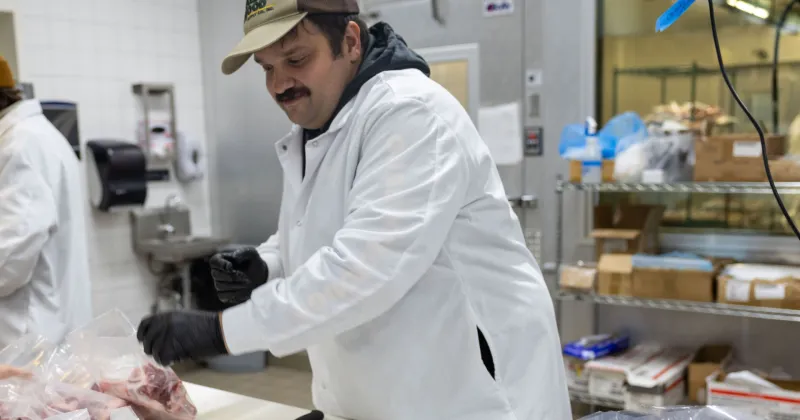 Artisanal Modern Meat Butchery student cutting up meat in class.