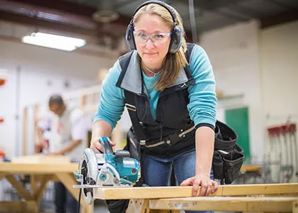 carpentry student working with a circular saw