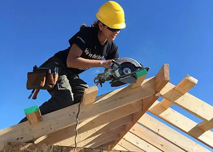 Madison College construction student working on a roof truss