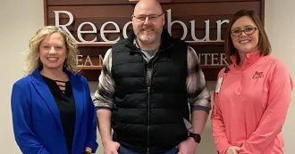 Jake Griebe poses for a photo with Madison College-Reedsburg staff.
