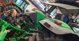 Madison College students working on a tractor.