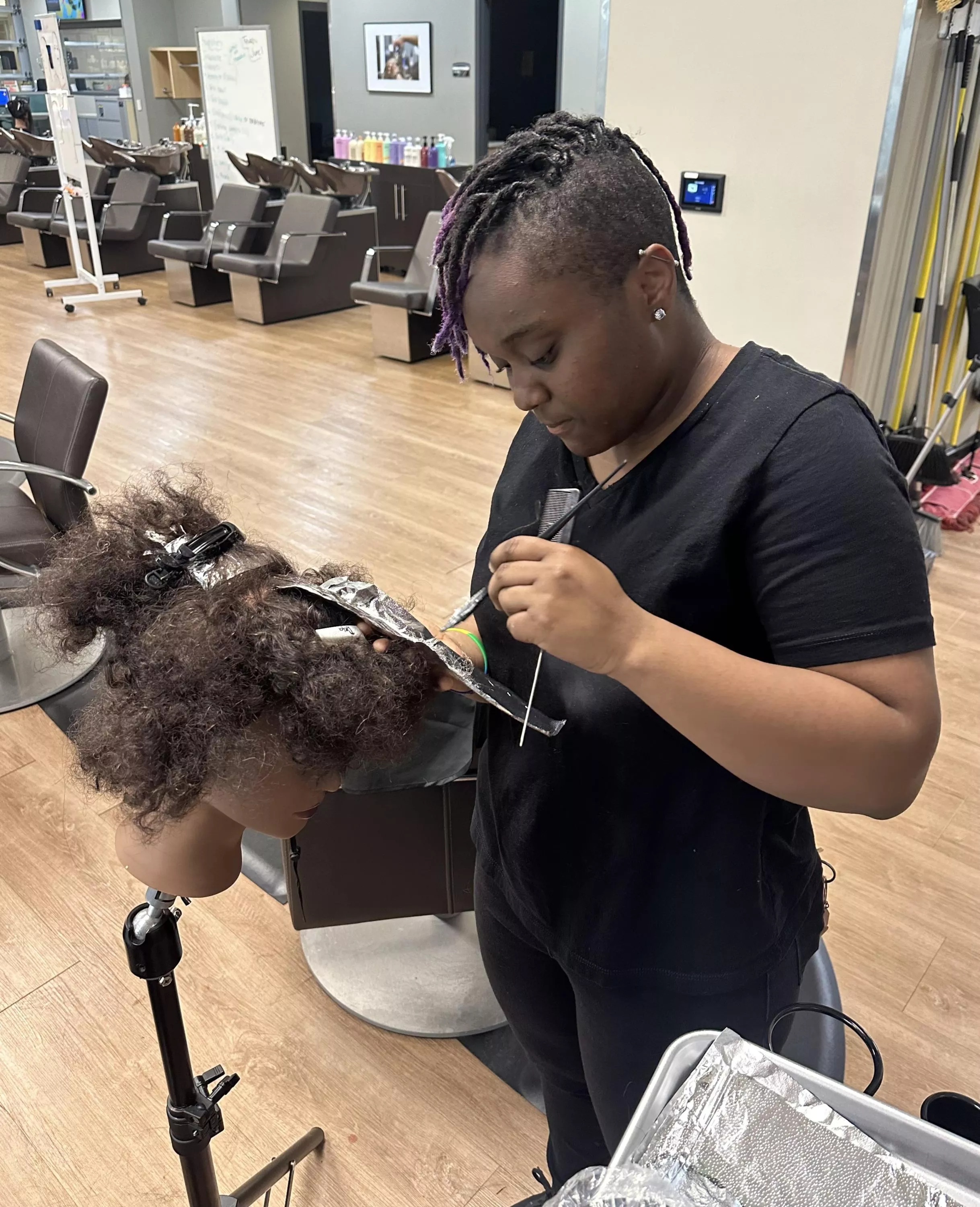 Cosmetology student practicing foiling