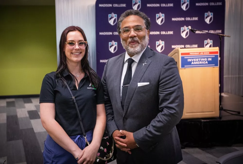 National Cyber Director Harry Coker Jr. poses with a Madison College student during visit.