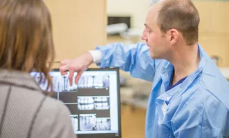dental hygienist with a client