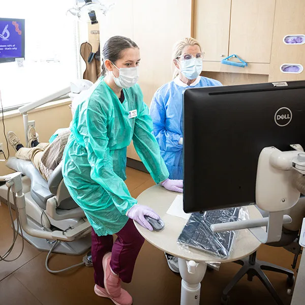 dental student and instructor reviewing patient x-rays