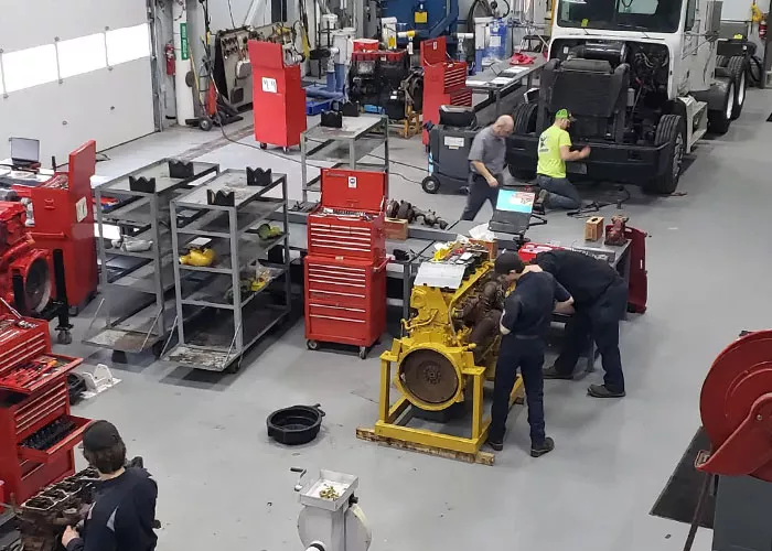 students getting hands-on experience in diesel engine repair class