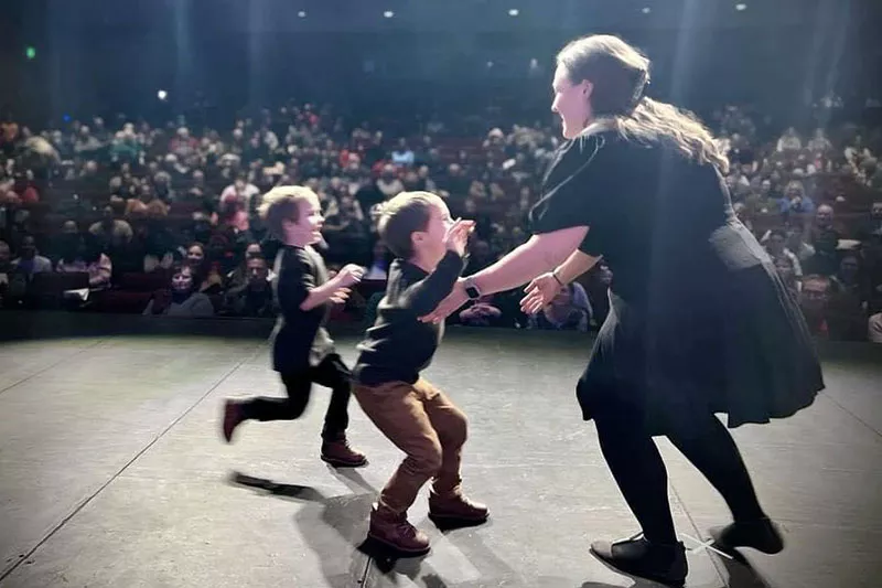 Emily Dolan’s sons run onstage during her Madison College pinning ceremony