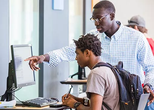 advisor working with a student