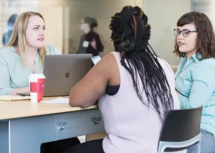 Three students having a discussion