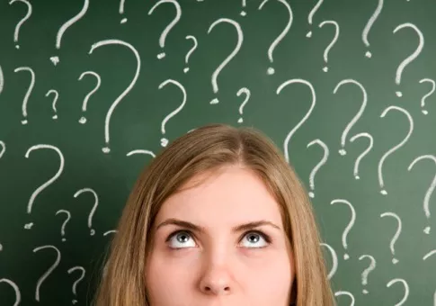 a person against over wallpaper filled with question marks