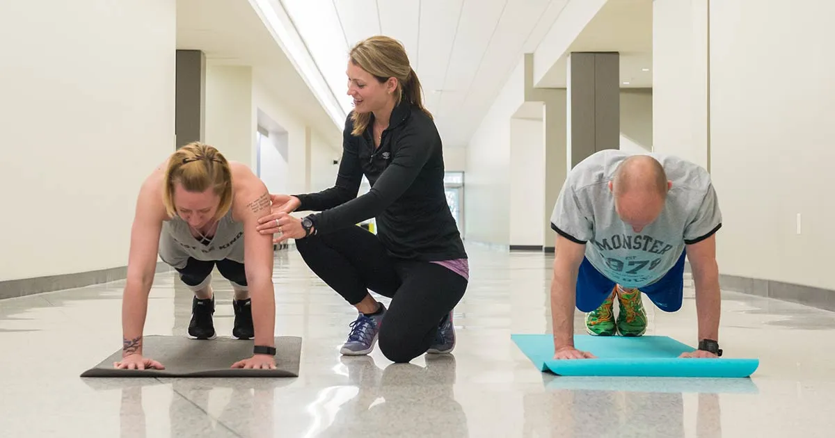 Instructor and two students on yoga mats