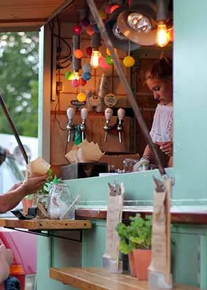 person inside a food truck giving food to customer