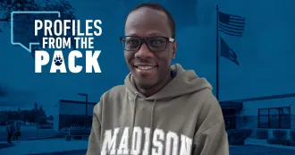 Photo of Franco Okello with a background of the Reedsburg campus behind him.