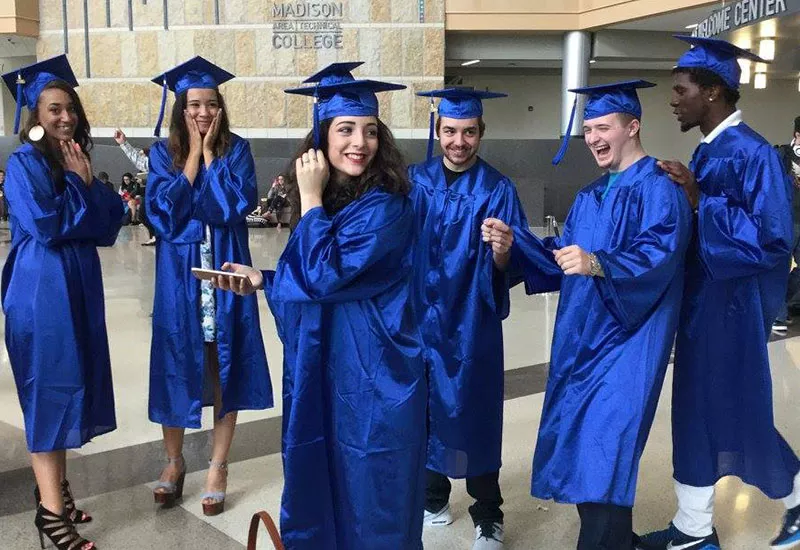 New Gateway to College graduates celebrating in caps and gowns