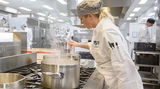 culinary student working on a stock