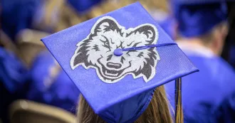 Cap of graduate with Wolfie mascot on it.