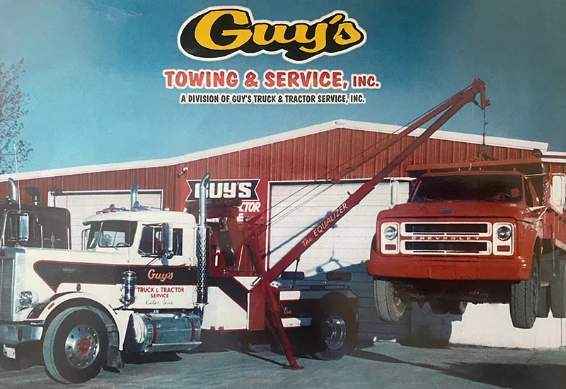 Guy's Towing promo photo featuring trucks