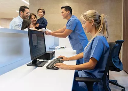 Healthcare receptionist checking in a client