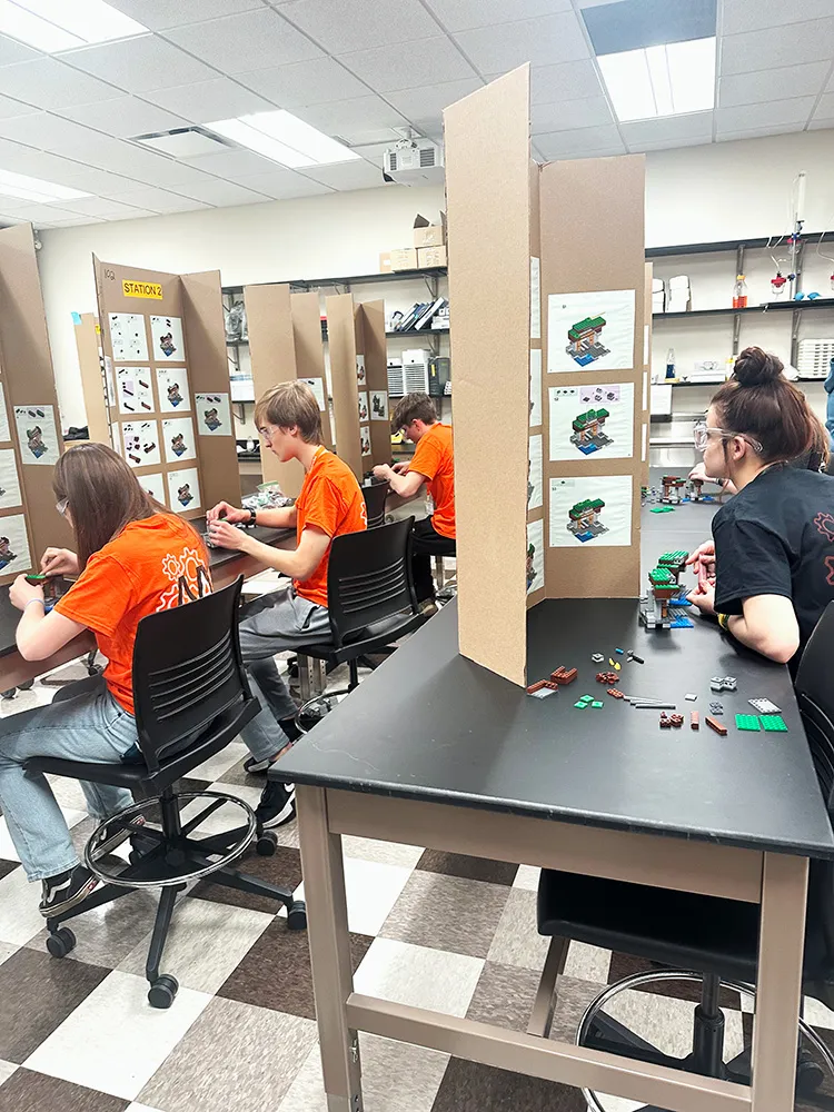 Students building with legos at Mini Manufacturing World event