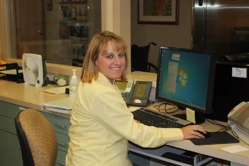 Keezia Wadsworth sits at a desk with a computer. 