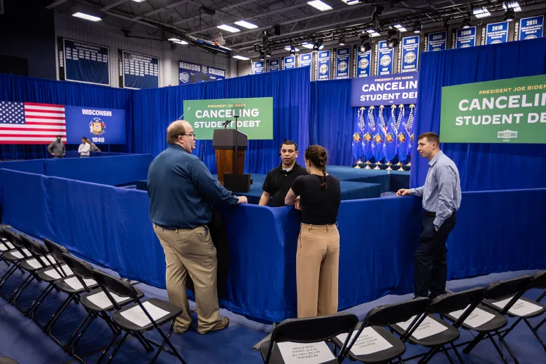View of a stage with signs that say "Cancelling Student Debt"