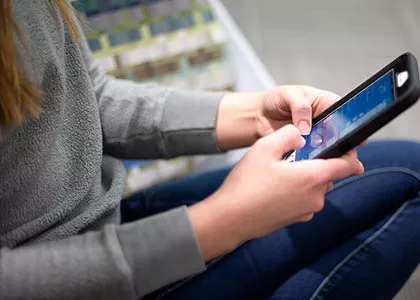 Pair of hands holding a smart phone