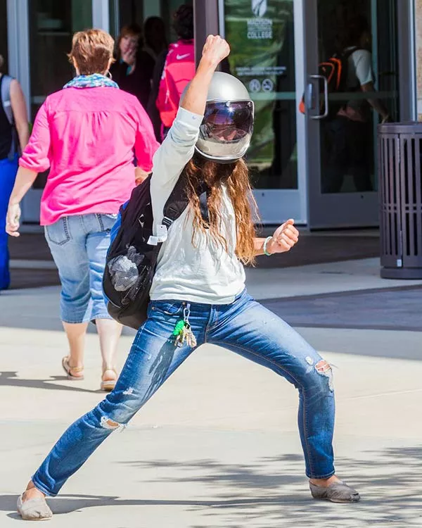 person wearing a motorcycle helmet with fist in the air
