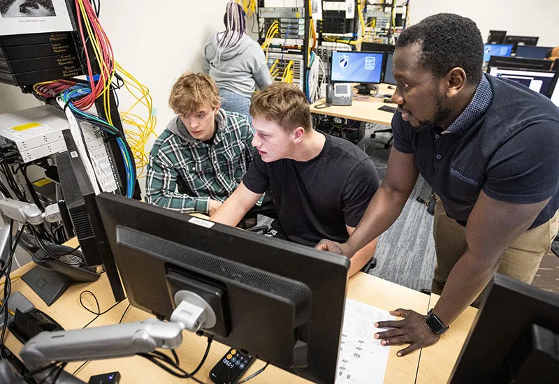 Network Systems Administration students discussing Phython scripting