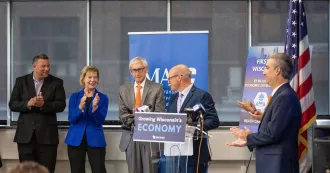 Photo Sen. Tammy Baldwin and Gov. Tony Evers at the July 22 press conference at MATC.