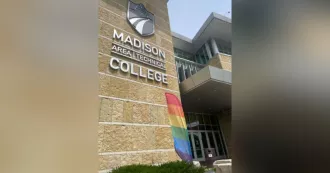 Pride flag flying outside the Madison College Truax campus entrance.