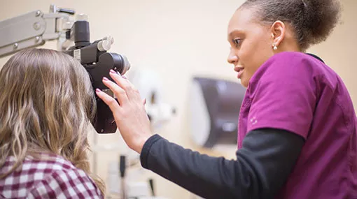 optometric technician working with a patient