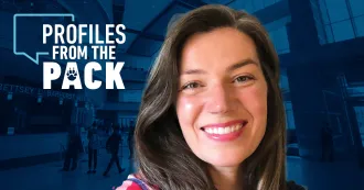 Courtney Dicmas, long brown hair, smiling with Profiles from the Pack logo in background.