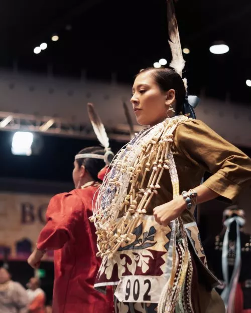 Person performing at a pow wow.
