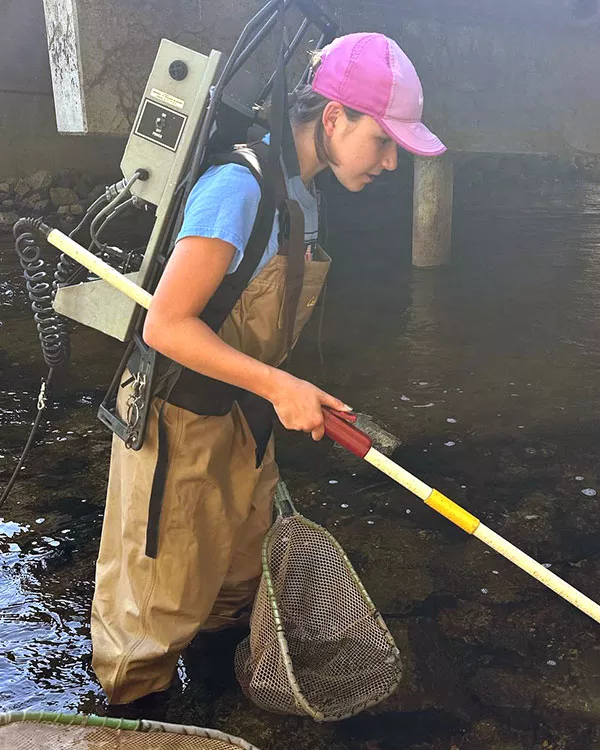 Madison College research student gathering data on a fish population