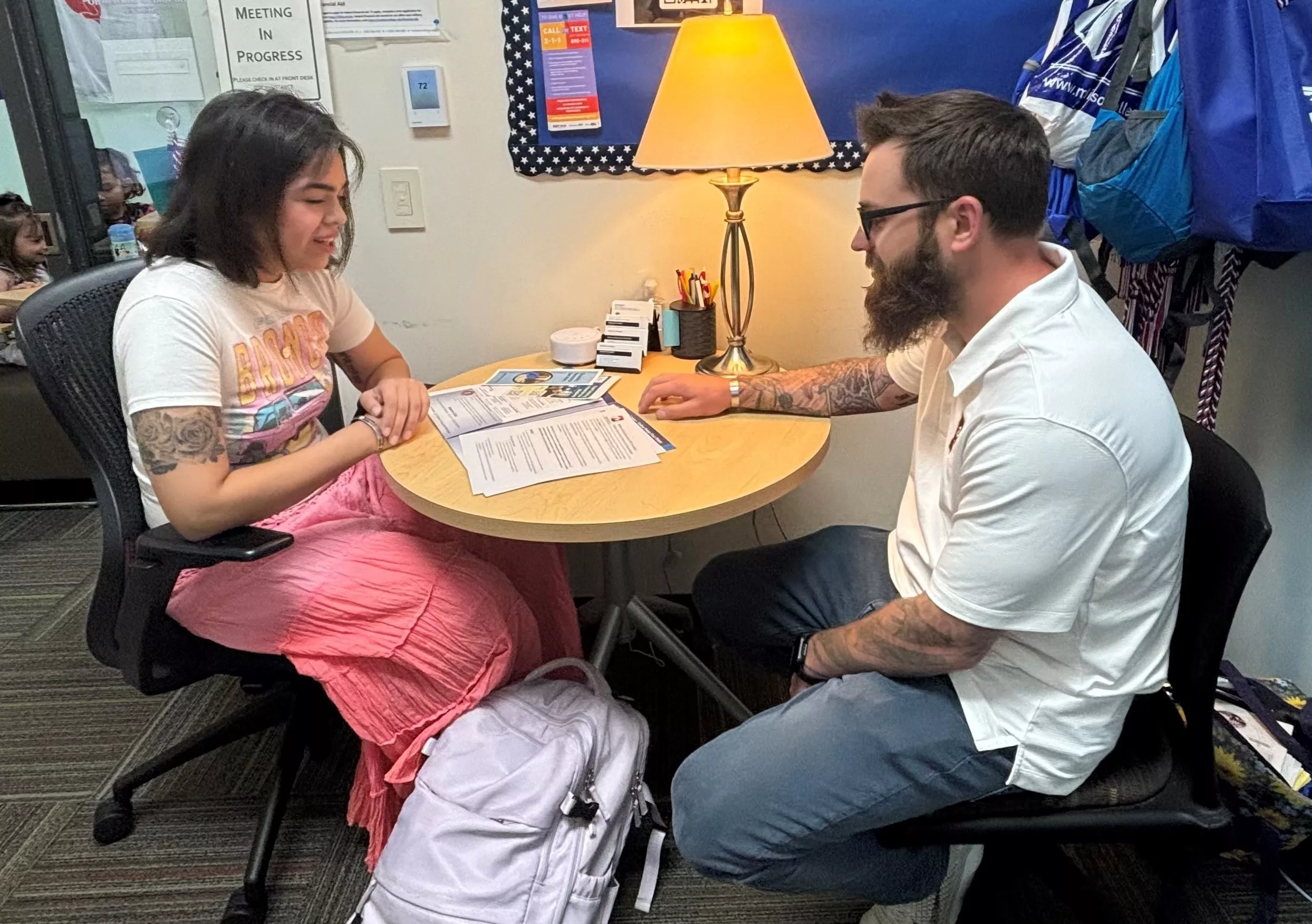 Veteran service staff Ryan Murphy with student