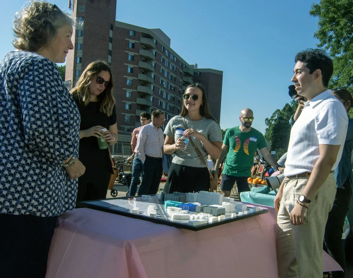 Student Sergio Perez stands next to a table with his 3D model on it as the City of Madison mayor looks on.