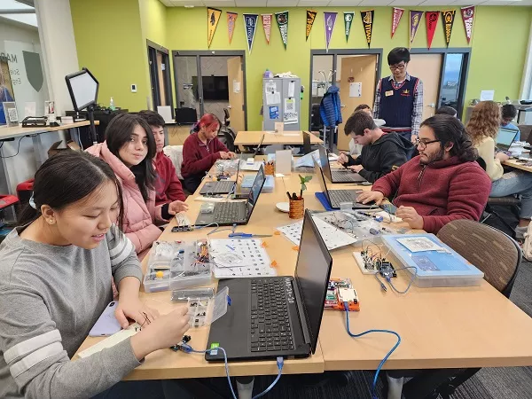 STEM students collaborating around a table