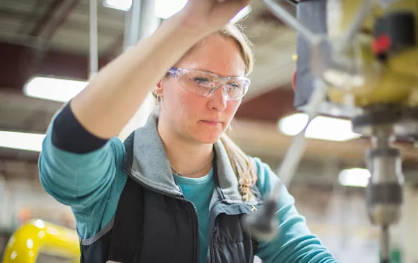 student using a drill press