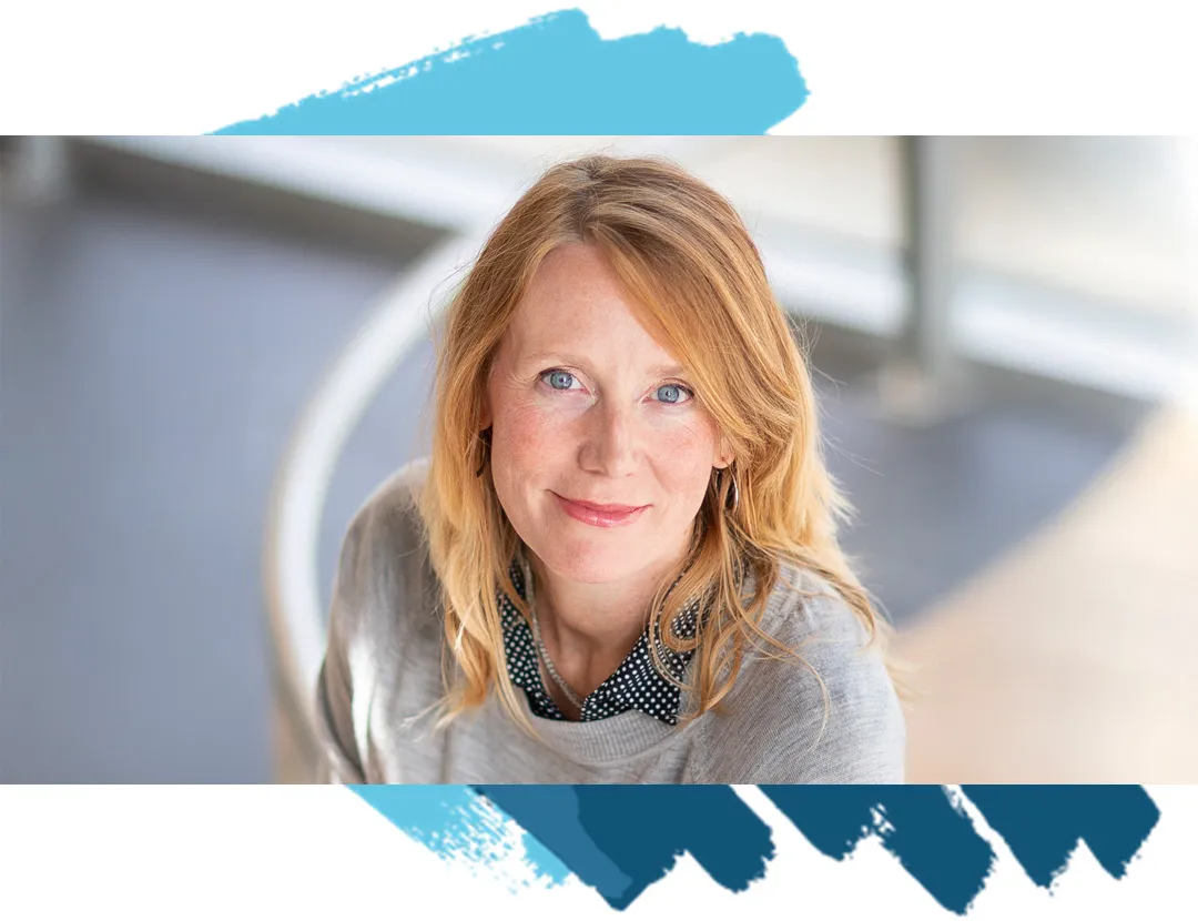 Belinda P. a blond woman wearing a gray shirt