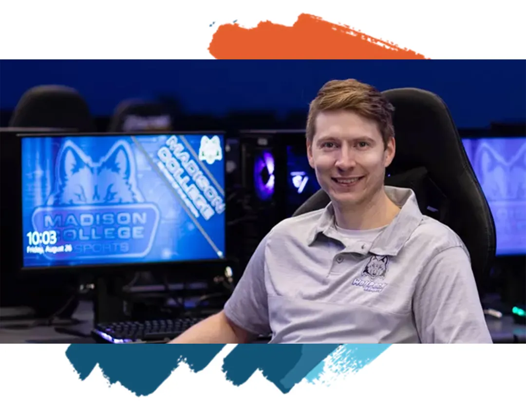 Shane smiling siting in a gaming chair