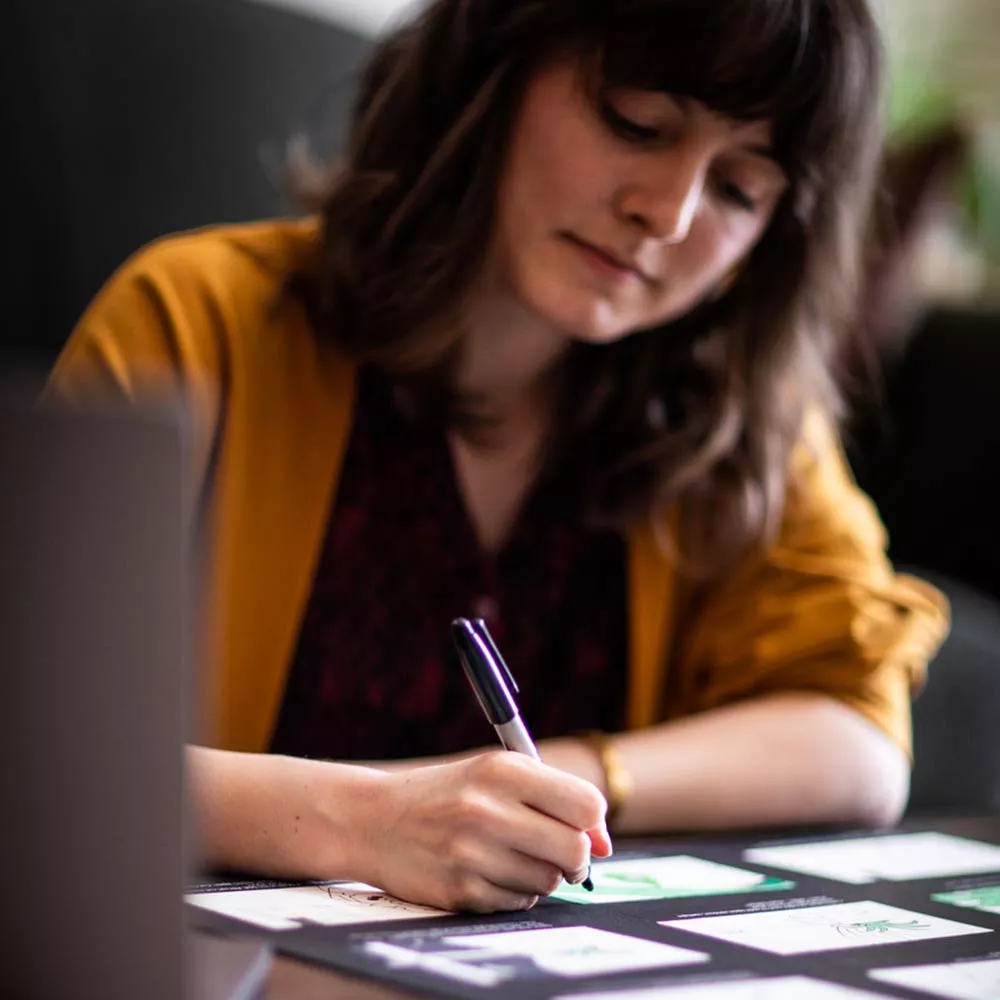 Student Meghan designing at a desk