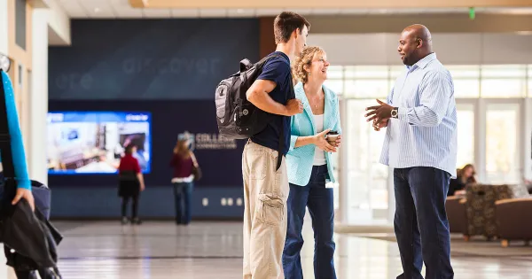 College navigator talking to a parent nad student